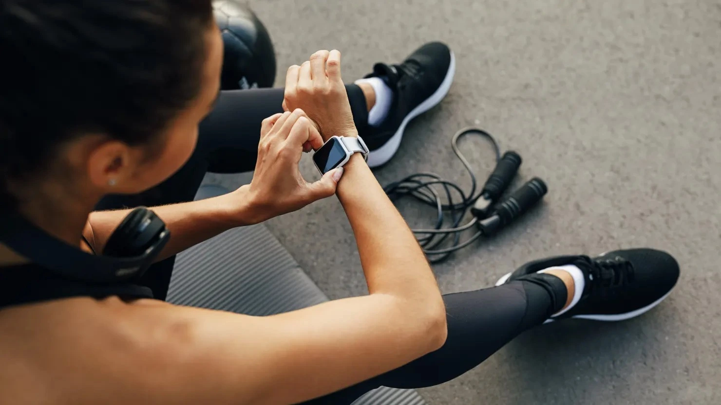 Health monitoring with smartwatch – Athletic person checking fitness data after training for an active lifestyle